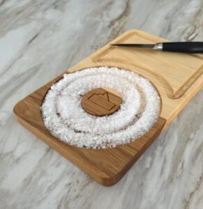 Top-down view of hickory cocktail rimmer board with knife rest and inlay