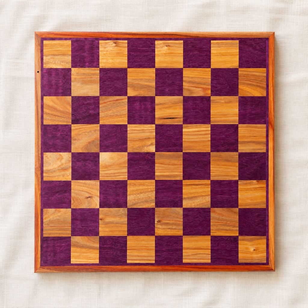 Top-down view of a handmade figured purpleheart and canarywood chess board with 2-inch squares, made in Canada