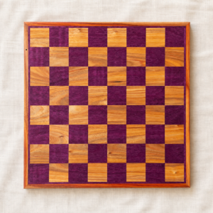 Top-down view of a handmade figured purpleheart and canarywood chess board with 2-inch squares, made in Canada