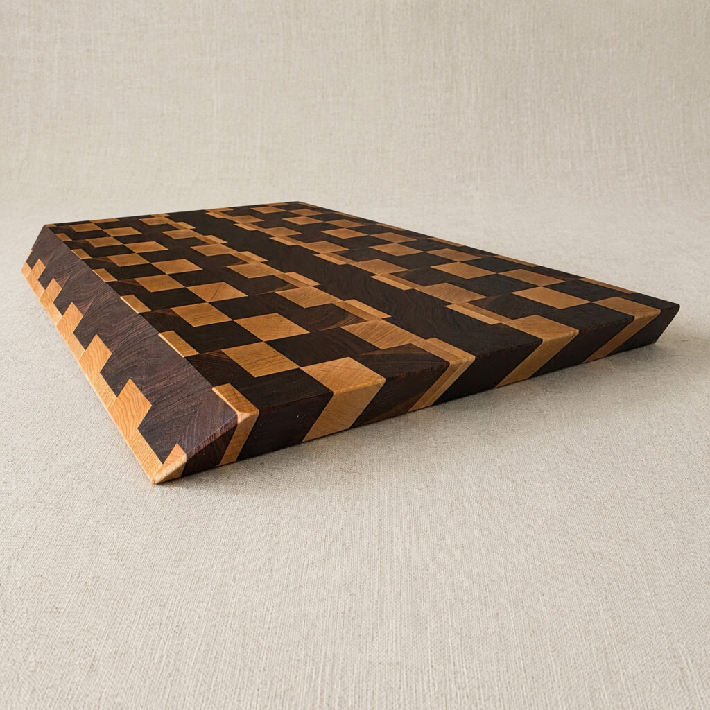 Citadel end grain cutting board in maple and walnut, 18 by 12 inches, shown at an angle